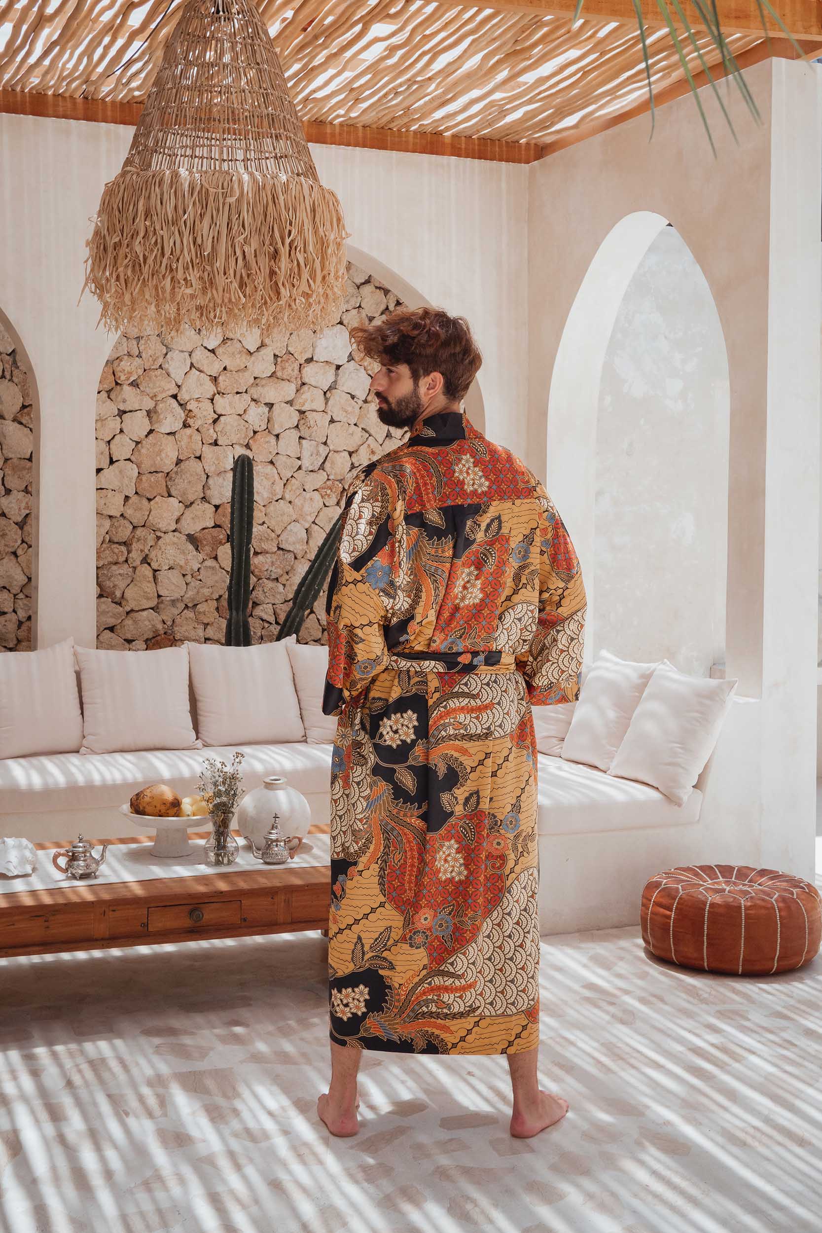 Back view of man wearing the Agni men’s kimono robe – elegant satin dressing gown with batik-inspired pattern.