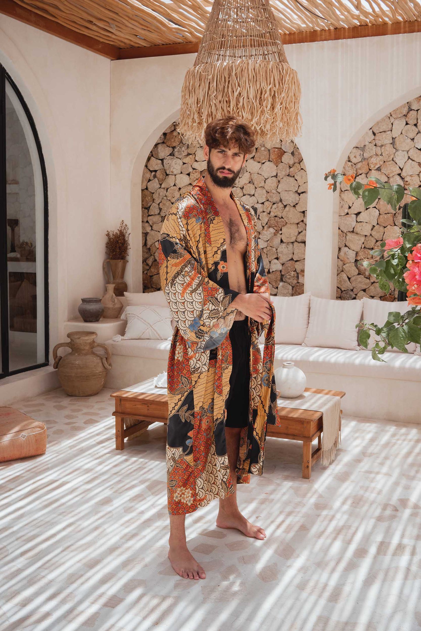 Side view of man in the Agni kimono robe – luxury satin dressing gown inspired by Balinese batik.