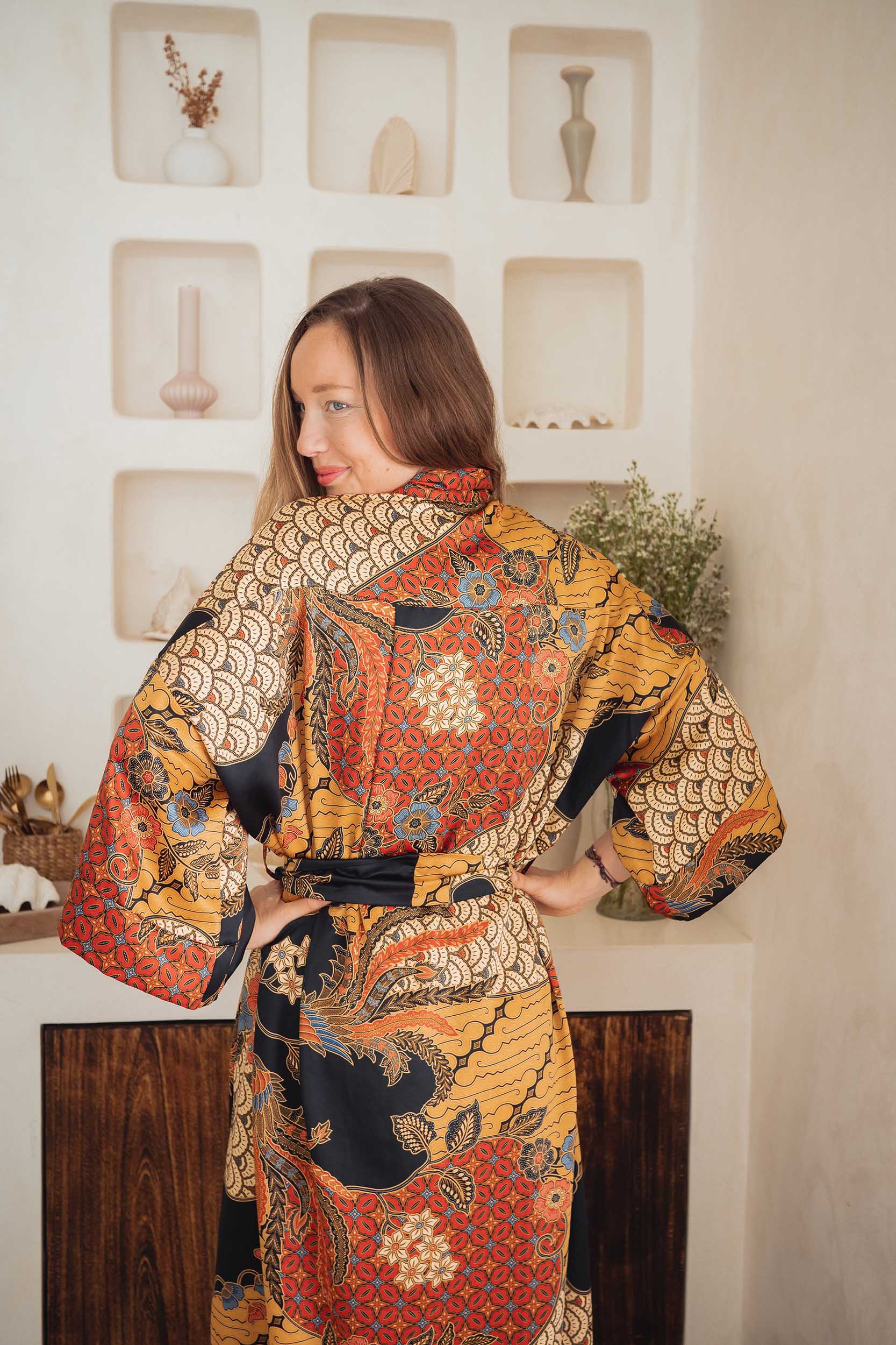 Back view of woman in the Agni kimono robe – luxury satin dressing gown inspired by Balinese batik.