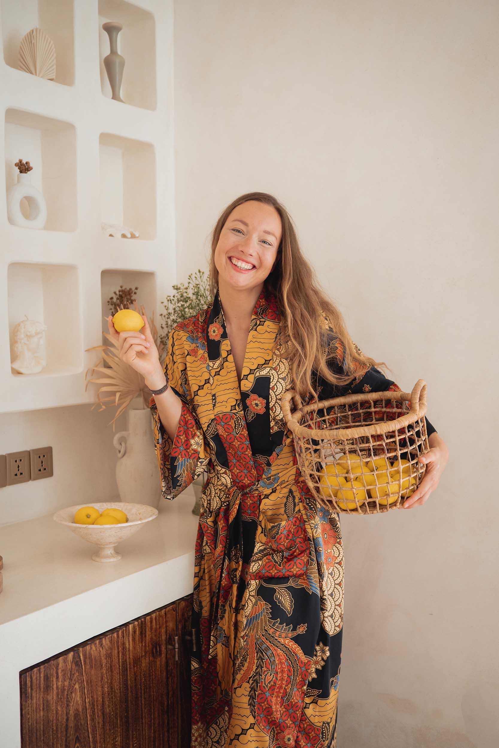 Front view of woman wearing the Agni women’s kimono robe – elegant satin dressing gown with batik-inspired pattern.