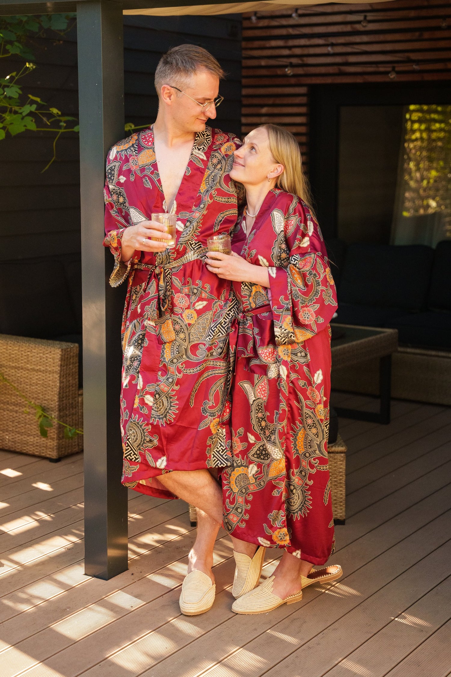Couple wearing matching kimono robes and raffia sandals outdoors