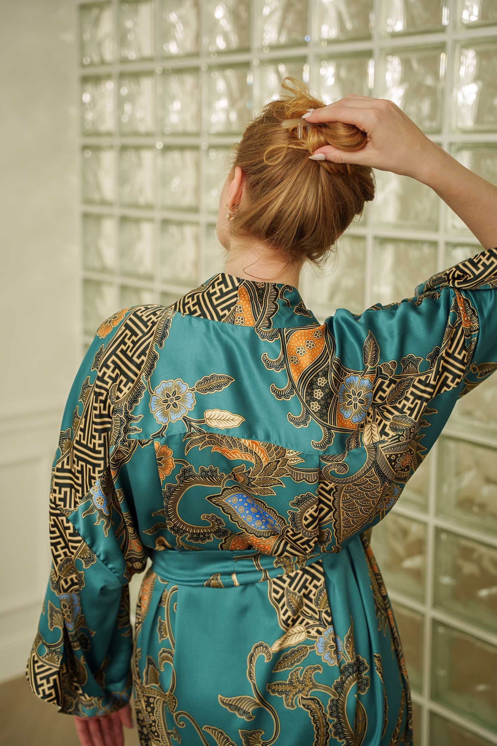 Back view close up of Lautan women’s kimono robe – teal satin with Indonesian batik design.