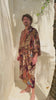 a video of Man wearing Toré Ratna kimono robe – long burgundy satin dressing gown with gold and cream batik pattern in Bali.