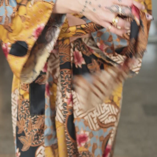 woman wearing womens satin kimono robe sorga - yellow black batik pattern
