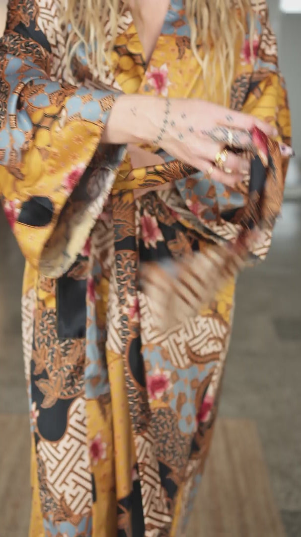 woman wearing womens satin kimono robe sorga - yellow black batik pattern
