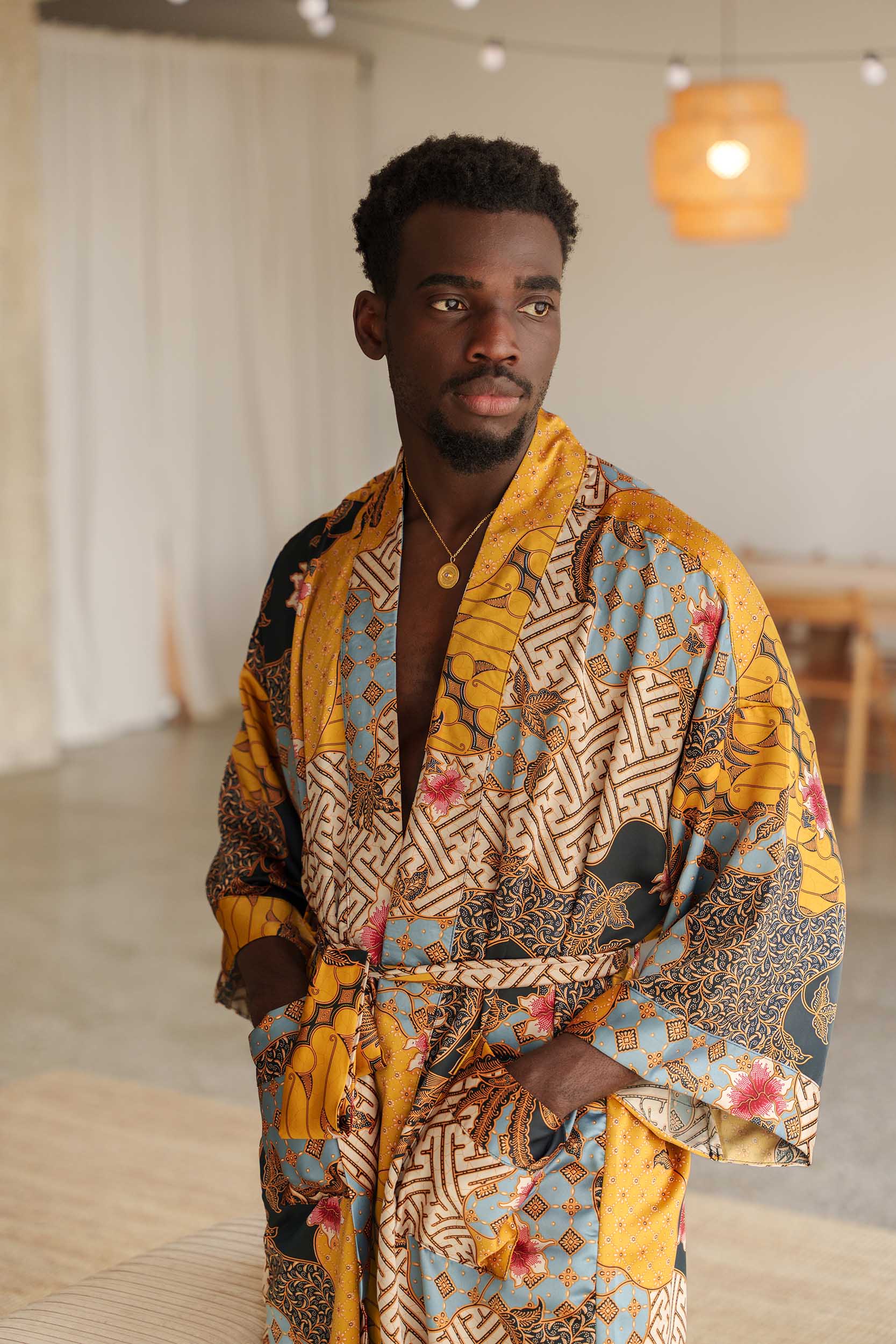 Man wearing Toré Sorga kimono robe – luxury satin dressing gown with pockets.