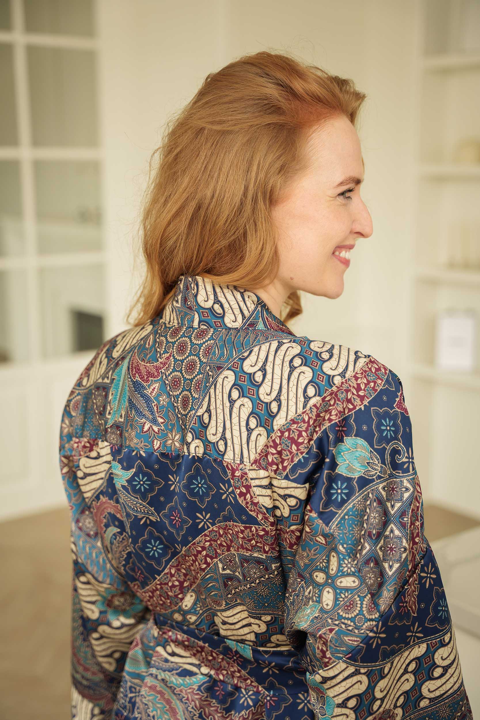 Close-up of Toré Angkasa kimono robe fabric – soft satin material with celestial batik pattern.