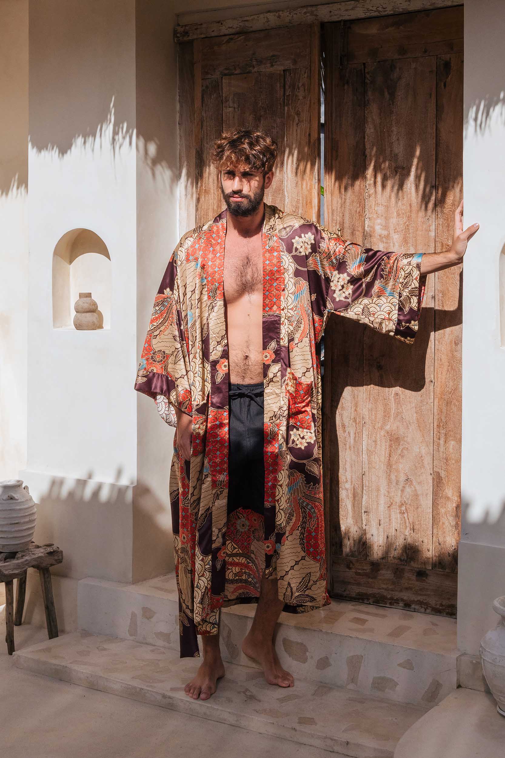 Man wearing Toré Bara kimono robe – long red and beige satin dressing gown handmade in Bali.