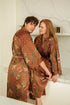 Couple wearing matching Toré Bumi satin kimono robes – handcrafted in Bali.