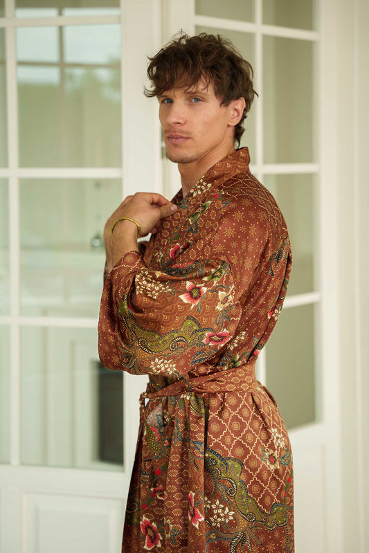 Side view of man in Toré Bumi kimono robe – long satin brown dressing gown with belt.