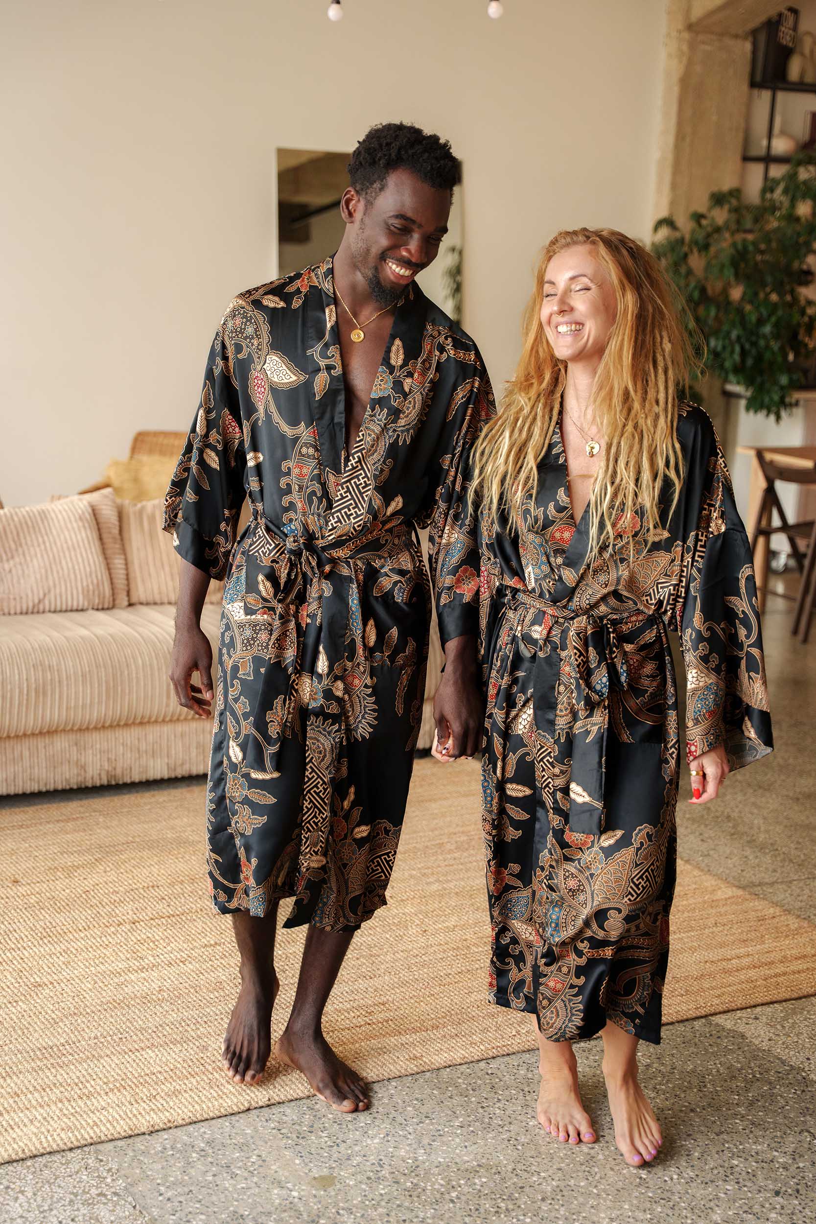 Man and woman in Toré Malam robes – luxury long couple kimono robes.