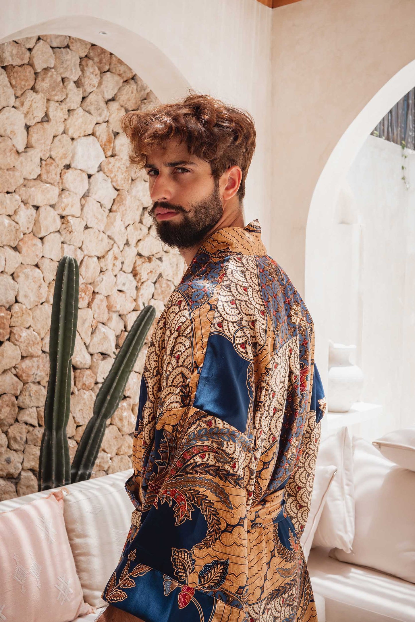 Back view of Toré Nilam men’s robe – blue and gold kimono with intricate batik details.