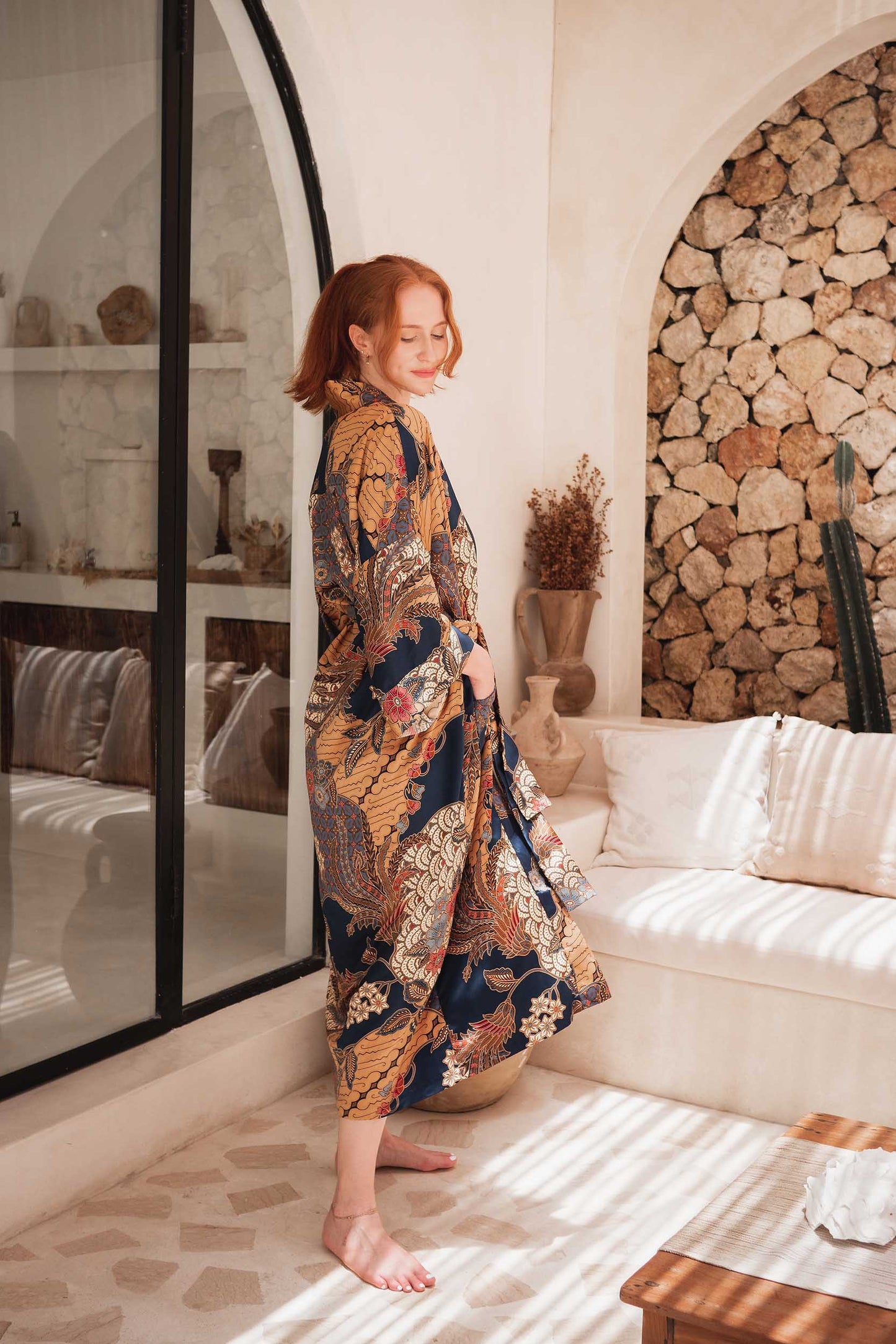 Side view of Toré Nilam robe – elegant women’s satin kimono with intricate Indonesian pattern.