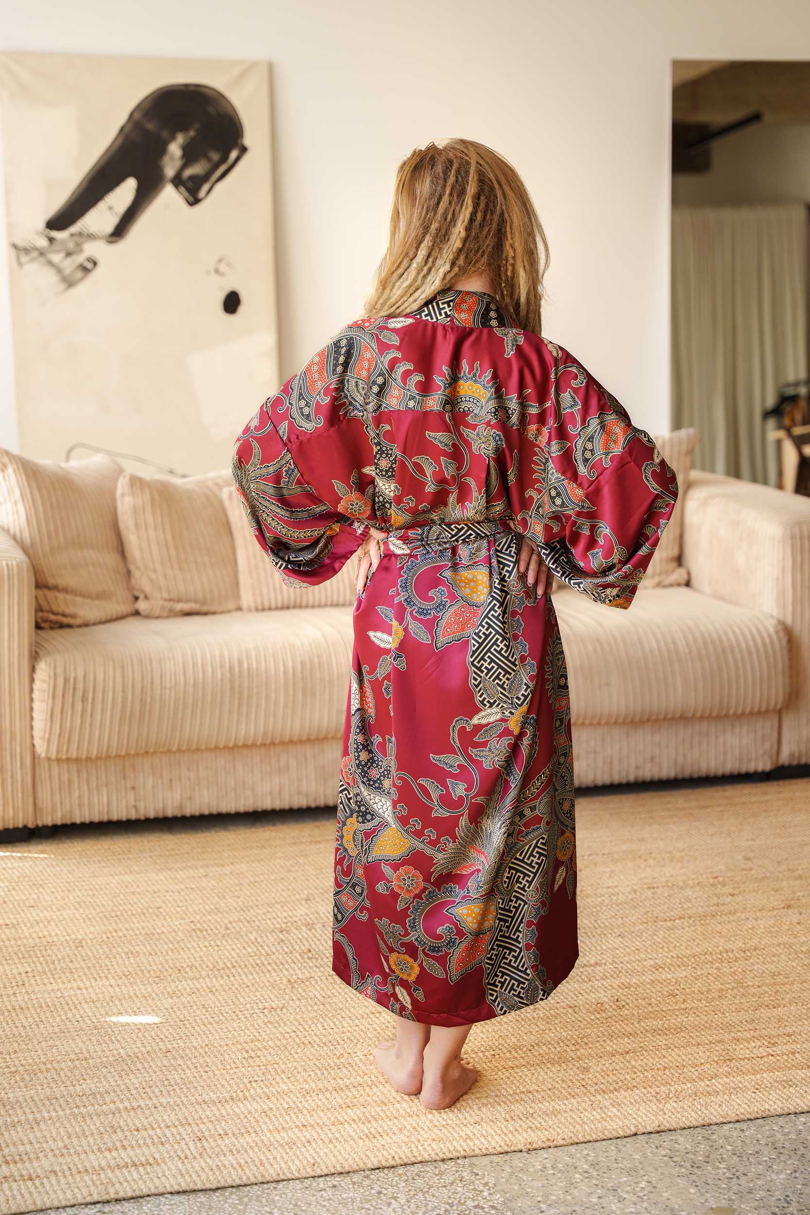 Back view of Toré Sekar robe – luxury red satin kimono for women with intricate batik design.