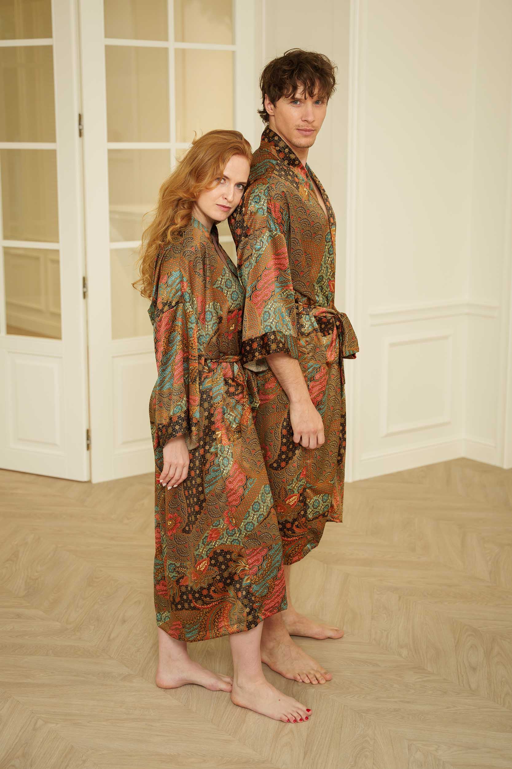 Two people wearing Semesta kimono robes standing in a room with wooden flooring and white walls.
