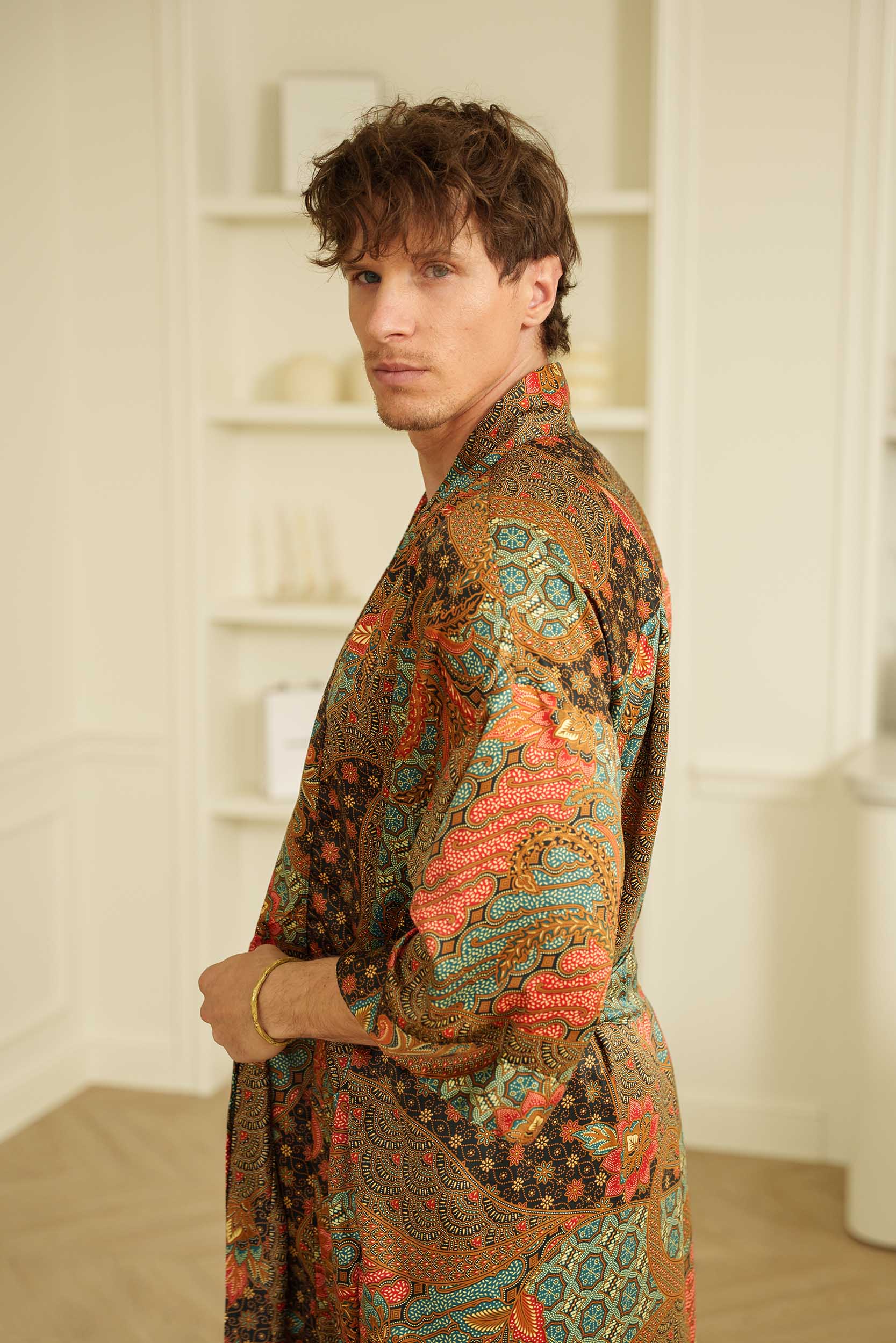Side view of man in Toré Semesta kimono robe – long satin brown dressing gown with belt.