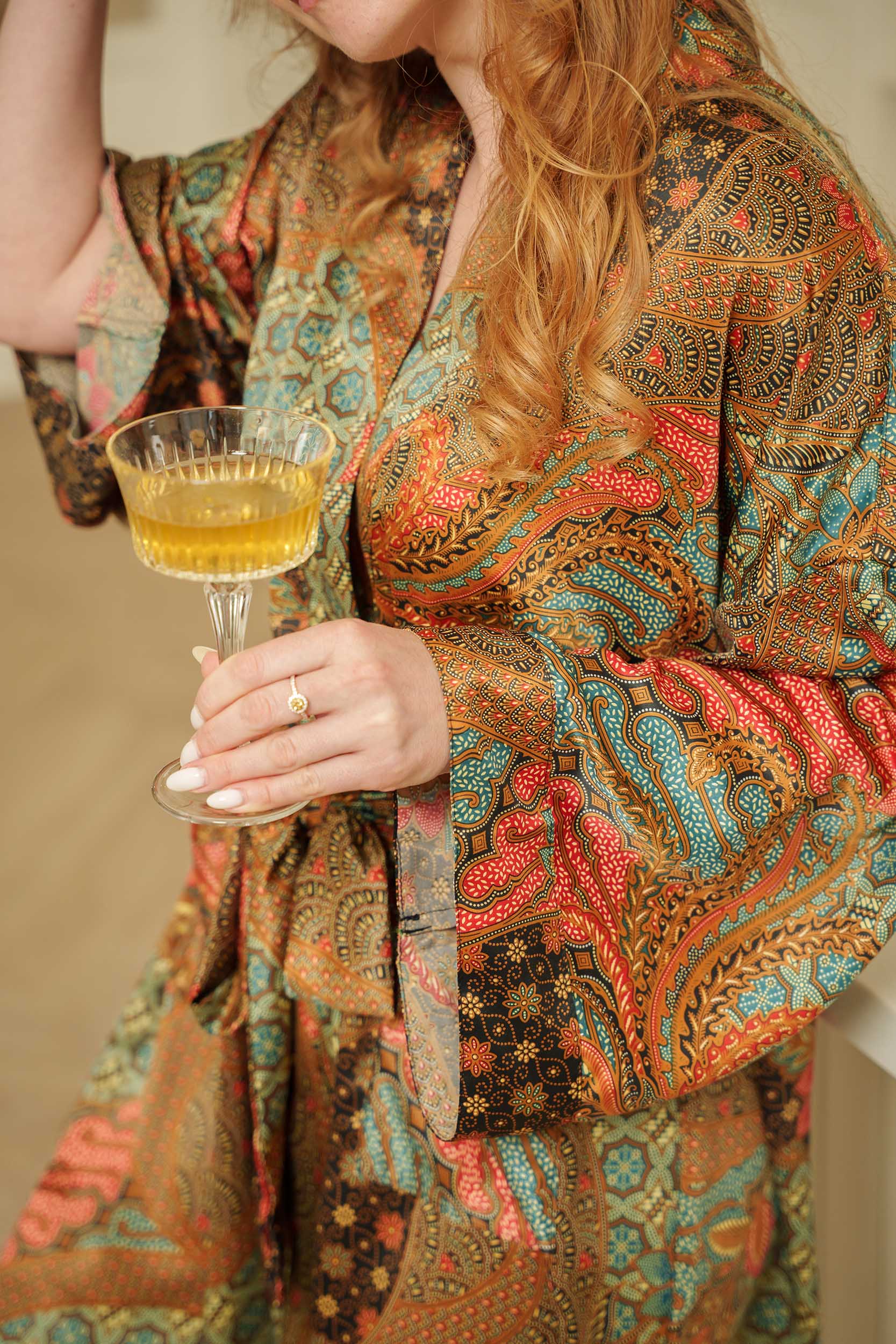 Close-up of Toré Semesta kimono robe fabric – smooth satin texture with Indonesian batik pattern.