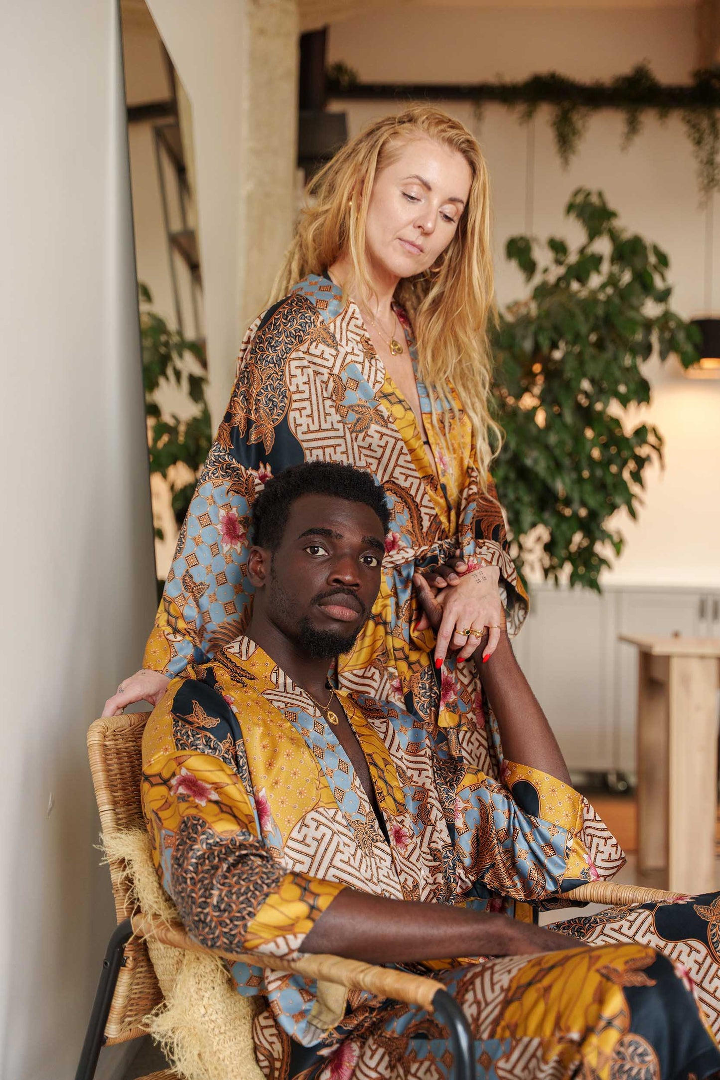 Man and woman in Toré Sorga robes – luxury couple kimono robes in radiant satin, perfect for anniversaries or weddings.
