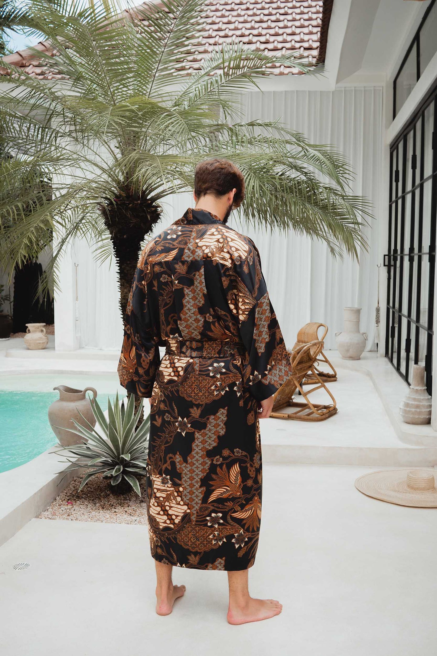 Back view of Toré Svarna robe – men’s black satin kimono with golden details.